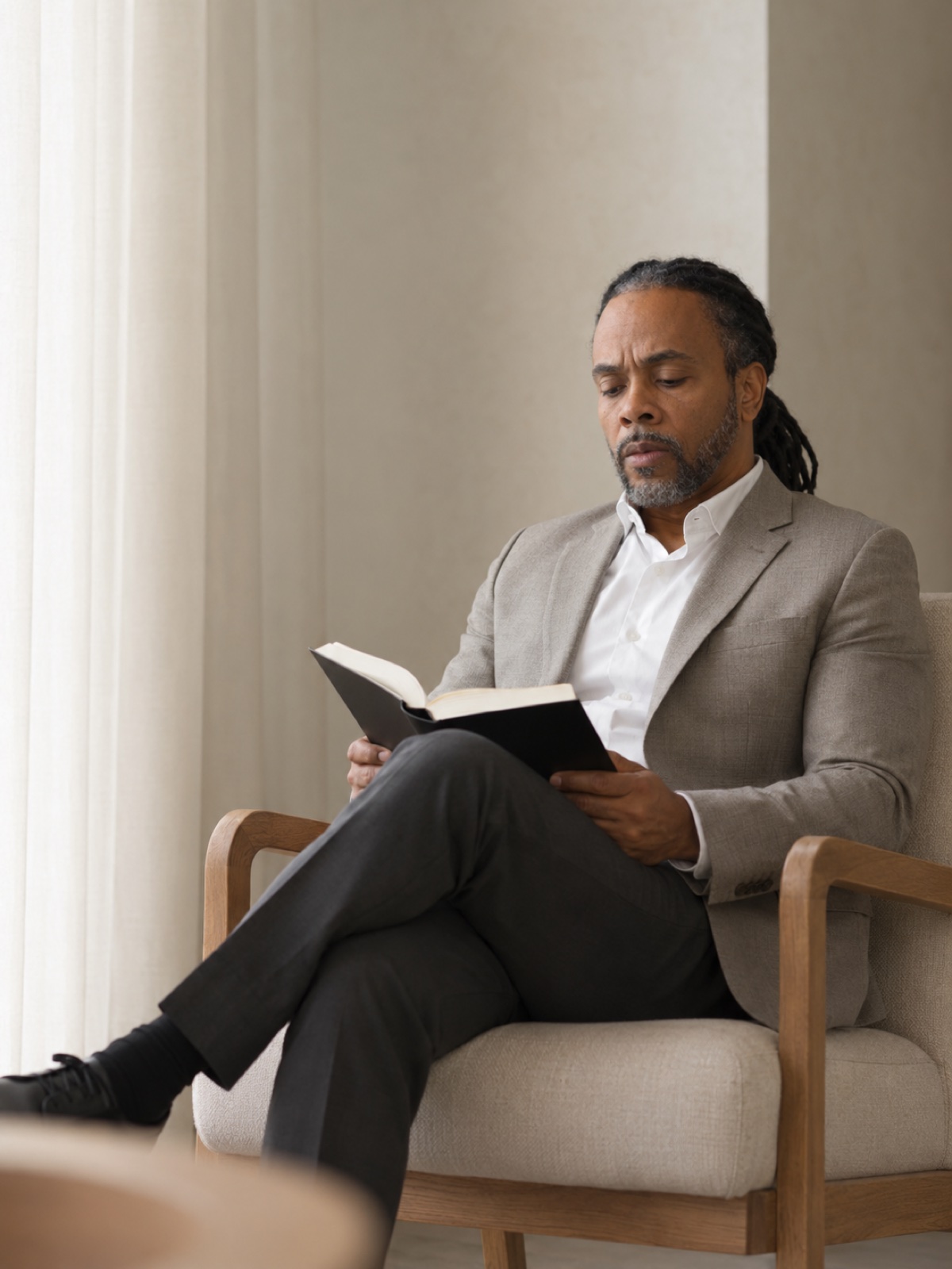 Supplied portrait of David Lynn quietly reading in a lounge